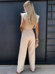 Chic elfenbensvit jumpsuit med elegant rosett detalj